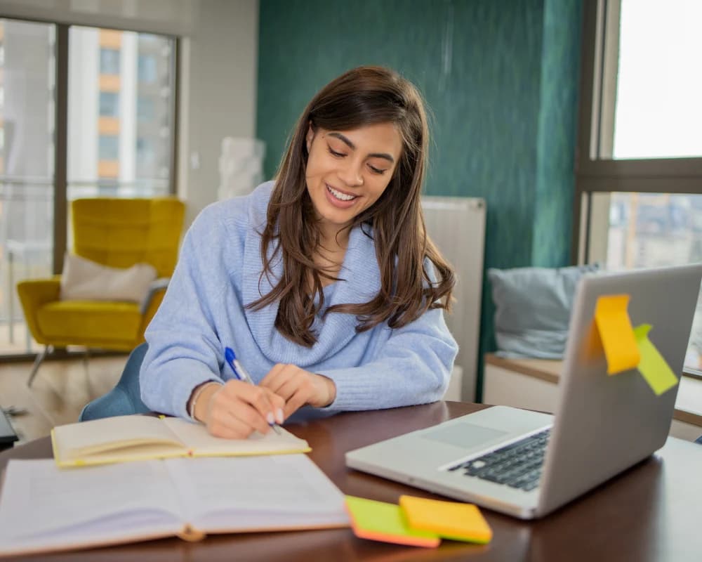 Student studying online with a laptop through an eLearning web portal.